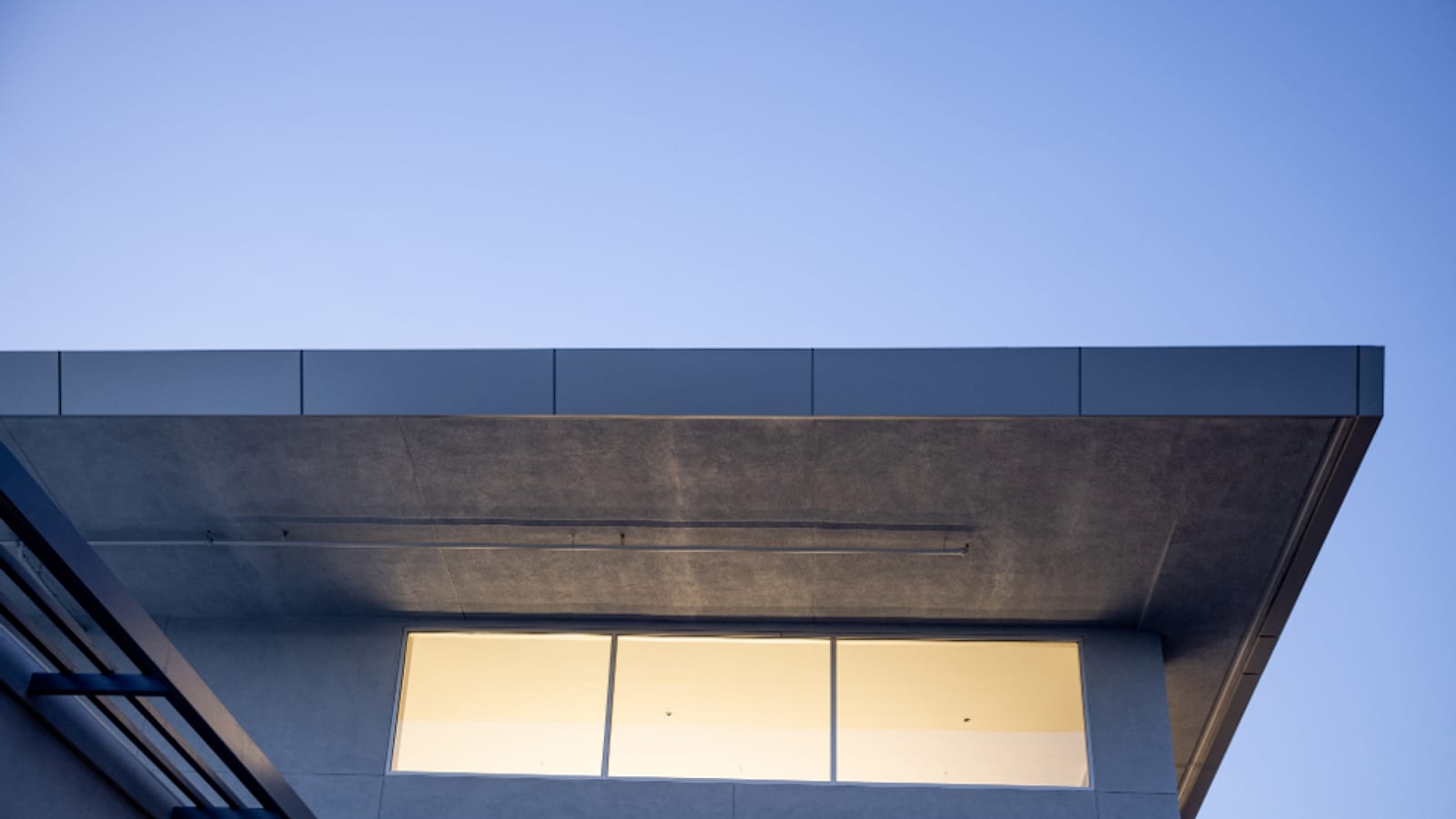 A modern roofline and soffit at dusk — representative backdrop
